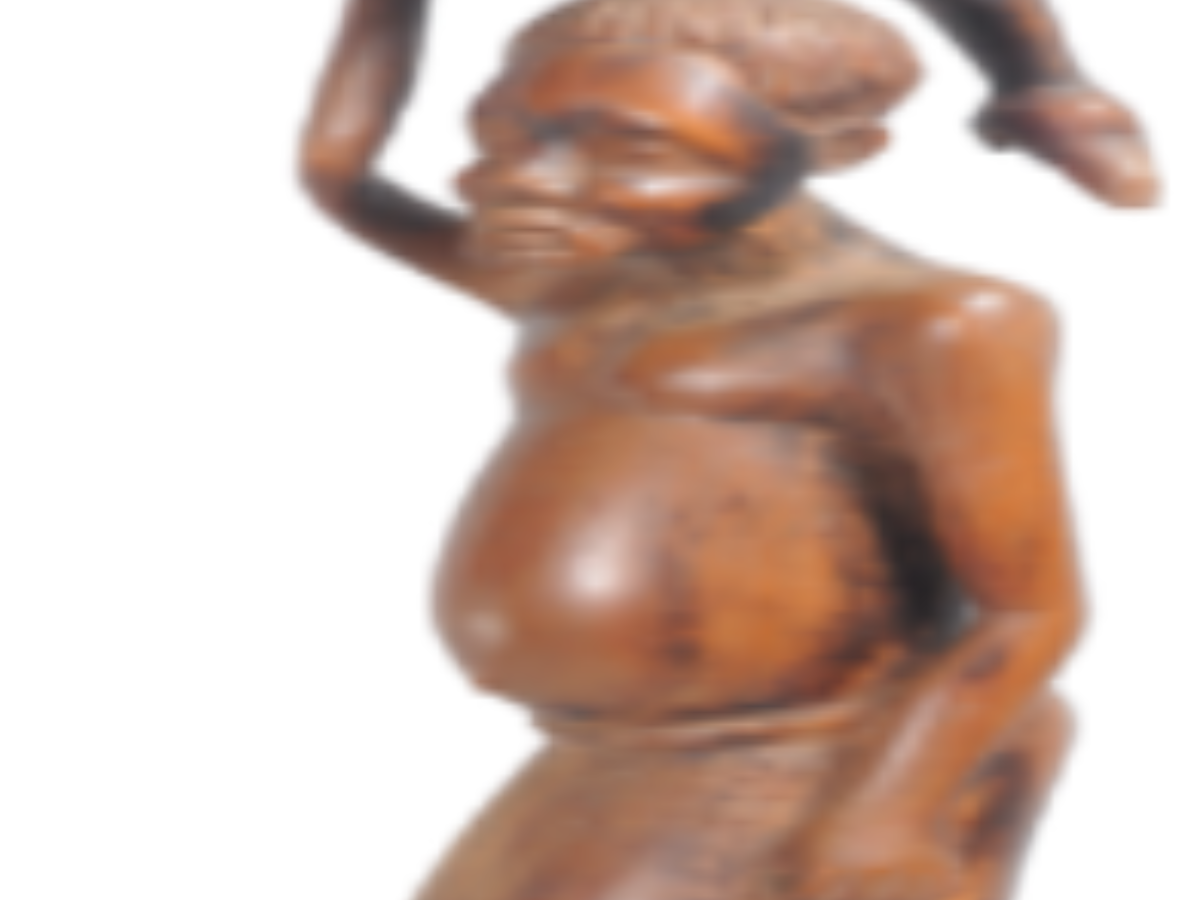 Wooden sculpture of a man carrying a deer Wooden sculpture of a man carrying a deer