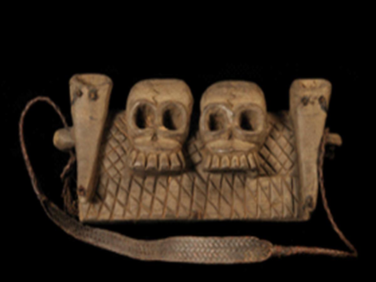 Two intricately carved wooden skulls Two intricately carved wooden skulls