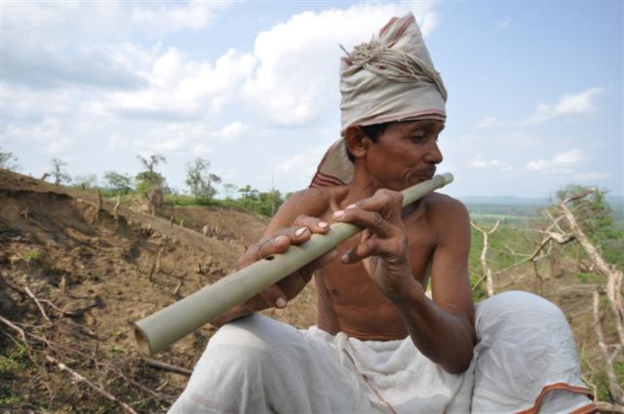 Tripuri man playing Bamboo flute Tripuri man playing Bamboo flute