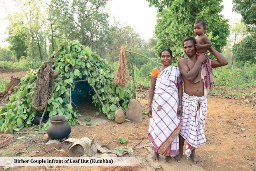 Birhor couple infront of leaf hut Birhor couple infront of leaf hut