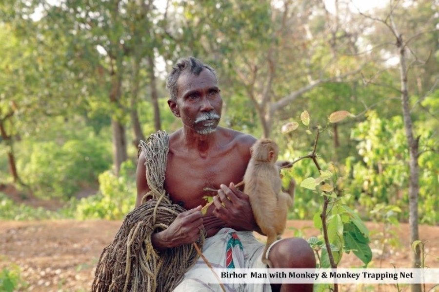 Birhor man with monkey and monkey trapping net Birhor man with monkey and monkey trapping net