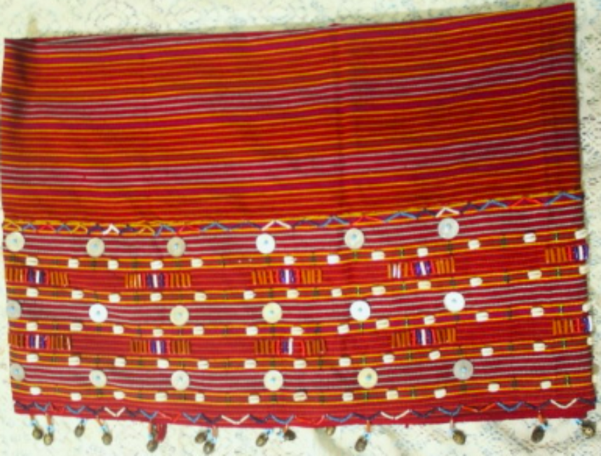 A Nyeesa (wrap-around skirt) worn by the chief’s wife or daughter is ornamented with beads. A Nyeesa (wrap-around skirt) worn by the chief’s wife or daughter is ornamented with beads.