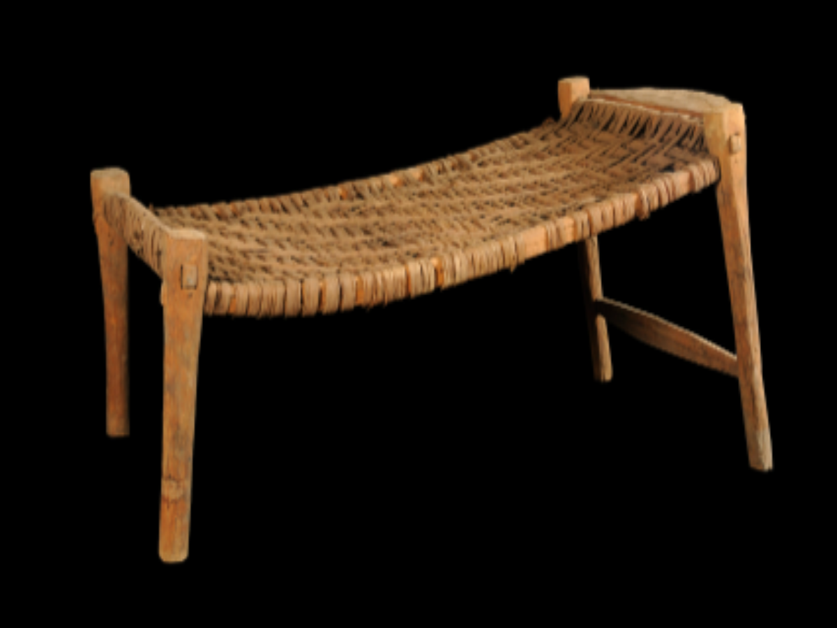 small, slanting wooden cot small, slanting wooden cot